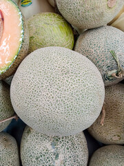 pile of fresh melons in the supermarket