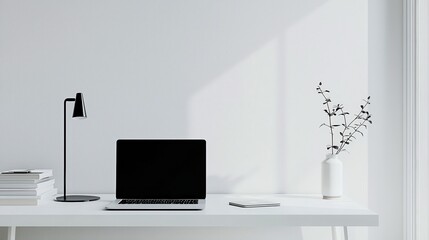 A clean, white workspace featuring a single sleek laptop centered on the desk. The minimalist decor and ample negative space create an open, modern aesthetic, perfect for adding text