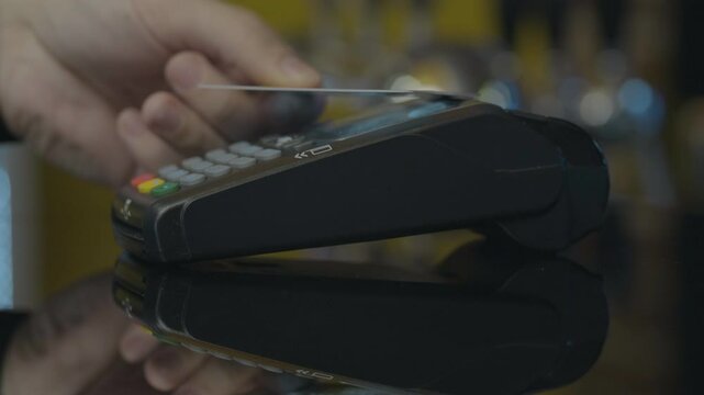 Close-up shot of person using mobile payment PayPass.