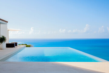 Obraz premium Relaxing infinity pool overlooking a serene ocean view on a sunny day in a luxurious beachfront villa