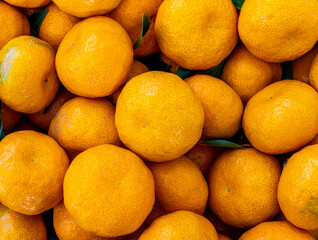 orange mandarin background of fresh juicy tangerines close up, vegan friut conception of citrus