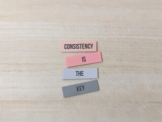 colored paper with the words Consistency Is The Key. education concept
