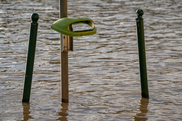 Budapest, Hungary - September 18, 2024: A Trash Bin Stands Submerged in Budapest’s Rising Floodwaters After Storm 'Boris'.