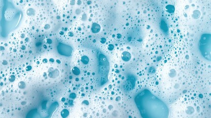 Natural soap foam texture with a light blue hue creating a clean and pure background ideal for themes related to cleanliness and washing
