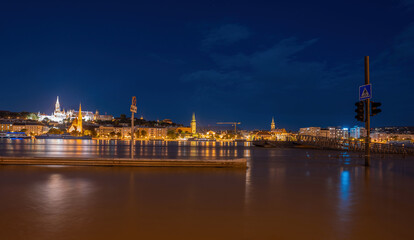 Fototapeta premium Budapest, Hungary - September 18, 2024: After Storm 'Boris': Fisherman's Bastion Towers Above the Flooded Danube in Budapest. Night long exposure shot.
