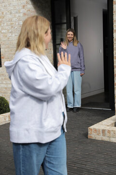 Women waving bye to each other