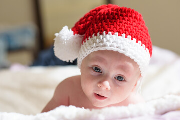 Beautiful baby in a Christmas hat isolated on white background