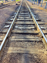 Fototapeta premium Rails in perspective, railway crossing in the city