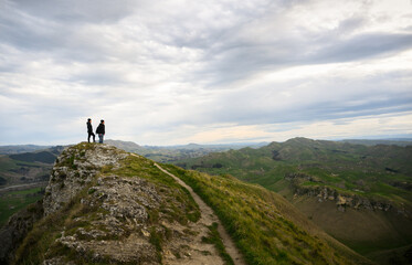 Fototapeta premium Couple standing on top of the hill. Te Mata Peak. Hawke’s Bay.
