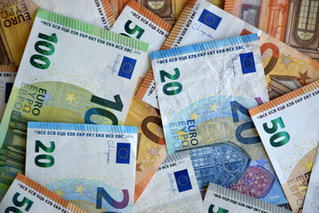 Many european euro money bills in chaotic arrangement. Pile of eur banknotes with different colors and condition