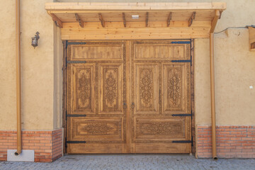 Carved antique wooden doors with patterns and mosaics.