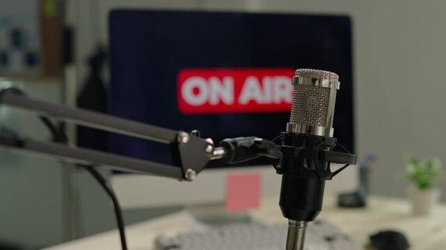 footage of close up microphone and on air red sign in record room for podcast radio in and live broadcast streaming