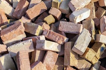 Pile of red bricks on a construction site. brick stacked background texture.