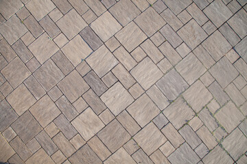 Close-up texture of beige stone background on pavement. Cement pavement