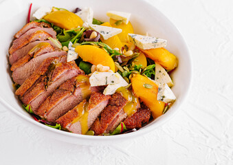 Delicious duck breast salad with peaches and blue cheese dressing