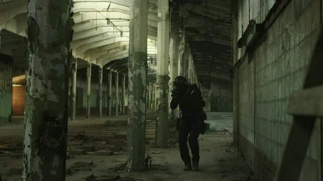 SWAT operator clearing an abandoned warehouse in black military outfit and an m4 assault rifle with a green laser