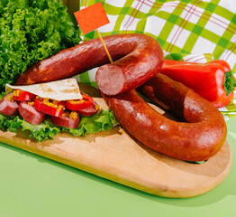 Smoked sausage with herbs and spices on a wooden cutting board