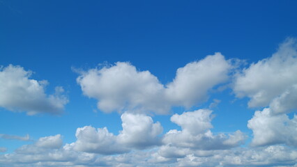 Beautiful cirrus and cumulus on different layers clouds visible in blue sky. Translucent cirrus spindrift clouds high up. Timelapse.