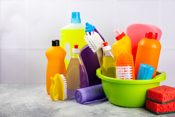 Cleaning service concept.Home cleaning product on a pink background. Bucket with household chemicals. cleaning supplies for home or office space.Early spring regular cleaning. Copy space