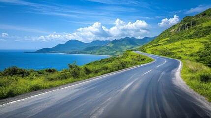 Naklejka premium Asphalt road and green mountain with sea natural landscape under blue sky