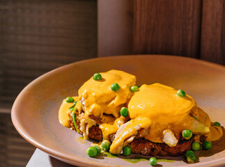 Delicious poached benedict eggs with hollandaise sauce served for brunch