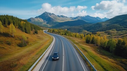 Fototapeta premium Scenic Road Through Mountain Landscape with Vehicle