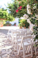 Row of folding chairs on cobblestone floor, versatile image for various settings and themes