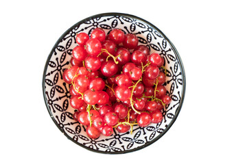 Red currant in the bowl on the gray cloth background. Large group.