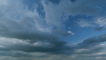 Obraz premium Dark sky with rain clouds before storm. Dark clouds storm bad weather. Dark clouds rolling cross sky. Timelapse.