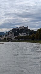 Naklejka premium Castle Hohensalzburg in the city Salzburg, view over the river, city landscape