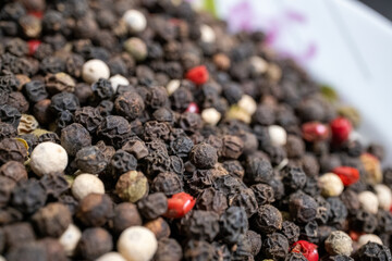 red and black pepper on white	