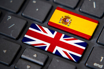 UK and Spain flags on computer keyboard