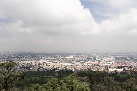 Expansive view over a bustling Mexican city from hilltop