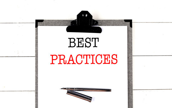 Business concept with best practices message on clipboard and pen on desk