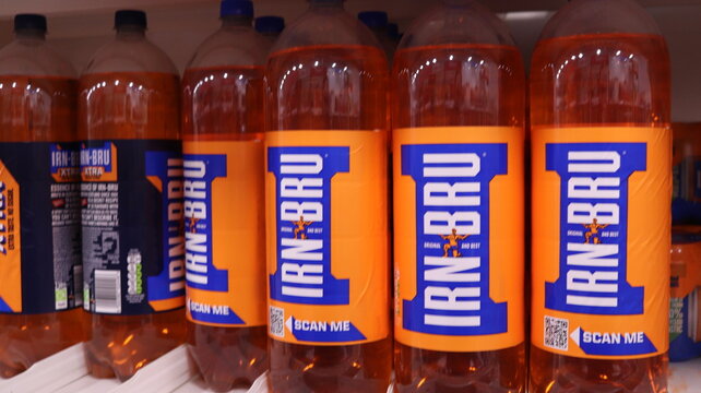 PONTYPRIDD, MID GLAMORGAN, WALES, UK - SEPTEMBER 25, 2024: IRN BRU BOTTLES SCOTTISH SOFT DRINK ON DISPLAY