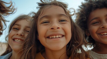 Fototapeta premium A close-up of three children with varied hair types, smiling joyfully