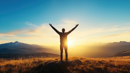 Person standing on hilltop during sunset with arms raised, embracing freedom and serenity, silhouette against sky.