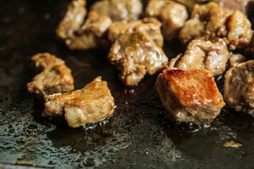 pieces of beef steak being grilled