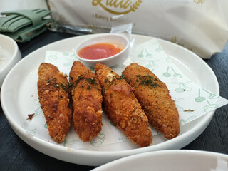 delicious Cheese Chicken Fingers served with spicy sauce