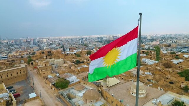 Photographing the Kurdistan flag with a drone over the Erbil Citadel in Iraq