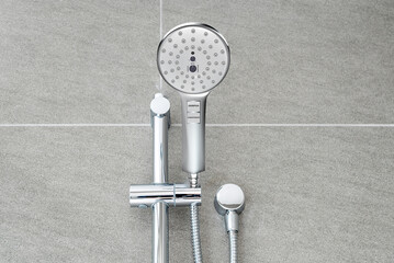 Silver shower head closeup in bathroom