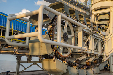 Industrial Conveyor Belt System. Close-up of a large industrial conveyor belt system, highlighting the intricate mechanics and structural components.