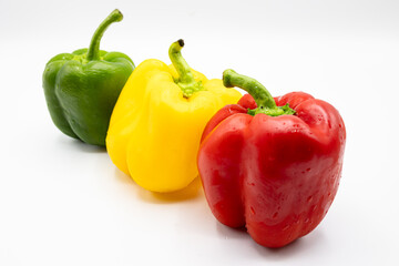 Three bell peppers, a red, a yellow and an green one