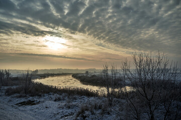 floes on the Warta River and snow-covered bushes and trees during winter