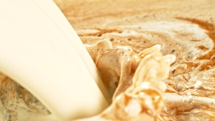 Macro Shot of Milk Mixing with Coffee Drink in Detail.
