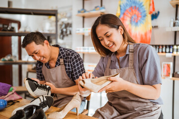 smiling female worker polish heels in shoe and care workshop