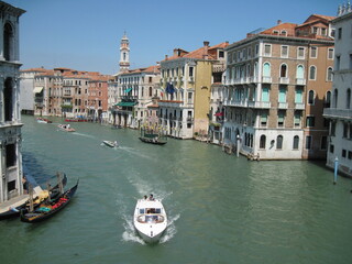 Obraz premium grand canal city. Romantic Venetian landscape. Tourists in a gondola on a walk along a Grand Canal in the old town. Famous historical heritage city.