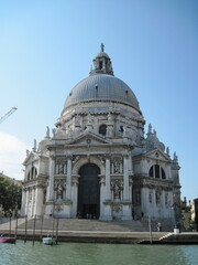 Fototapeta premium st mark cathedral city. Romantic Venetian landscape. Tourists in a gondola on a walk along a Grand Canal in the old town. Famous historical heritage city.