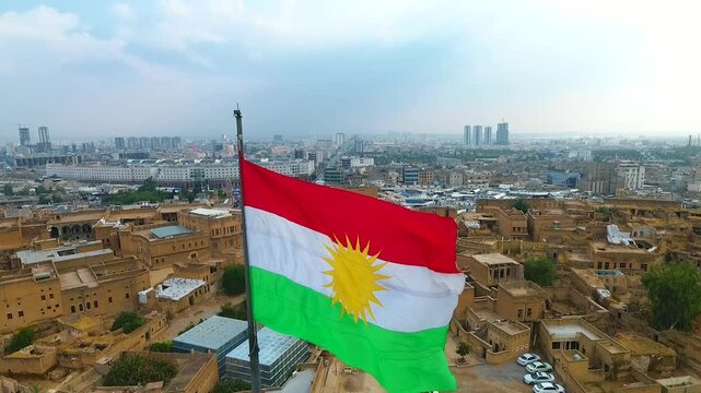 Photographing the Kurdistan flag with a drone over the Erbil Citadel in Iraq