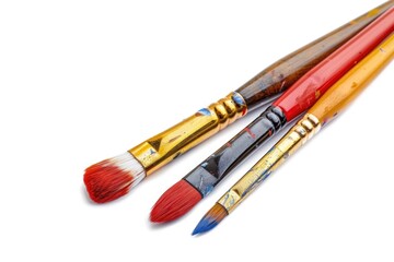 Fototapeta premium Three paintbrushes sit side by side on a clean white surface, ready for artistic use